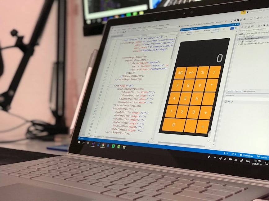 Close-up view of a laptop displaying a screen filled with lines of HTML code on the left and a large, orange calculator interface on the right, with visible buttons for basic operations and a blank di